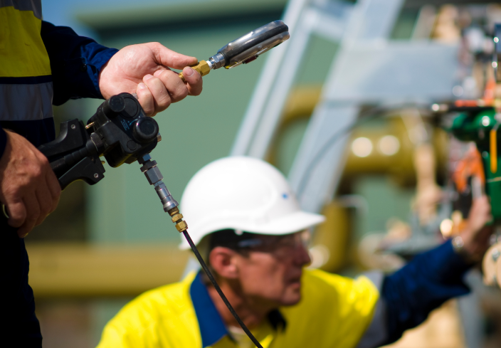 Two gas fitters working outdoors